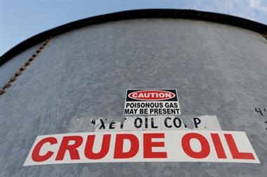 FILE PHOTO: A sticker reads crude oil on the side of a storage tank in the Permian Basin in Mentone, Loving County, Texas, U.S. November 22, 2019. REUTERS/Angus Mordant/File Photo 