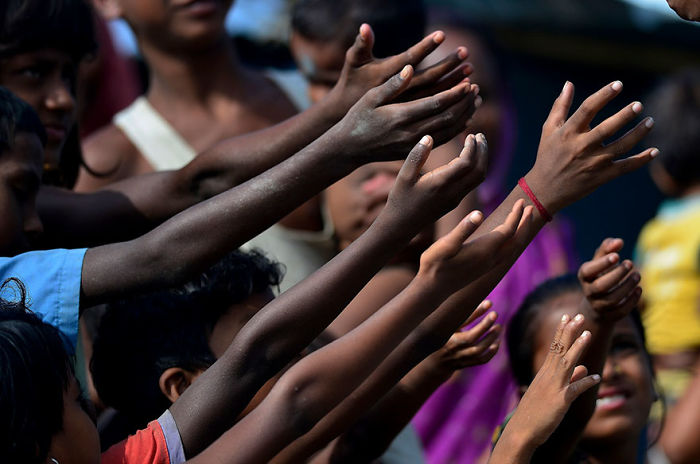 Children Raise Their Hand For Biscuit Packets, Being Distributed By Volunteers At A Hastily Constructed Camp In Assam State Where More Than A Million People Have Lost Their Homes