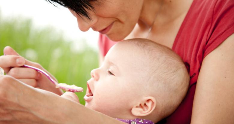 mom feeding a baby