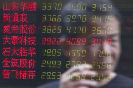 An investor is reflected on an electronic board showing stock information at a brokerage house in Shanghai, China, July 3, 2015. China stocks slumped again on Friday, taking their three-week tumble to nearly 30 percent and wiping out most of this year's gains. REUTERS/Aly Song
