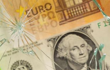 U.S. dollar and euro banknotes are seen through broken glass in this illustration taken, June 25, 2021. REUTERS/Dado Ruvic/Illustration 