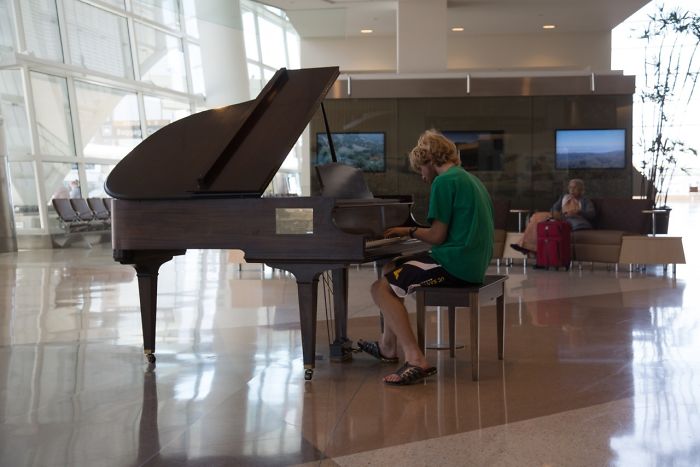 In The Lobby Of The San Jose International Airport, There Is A Piano, And Next To This Piano Is A Sign Reading 