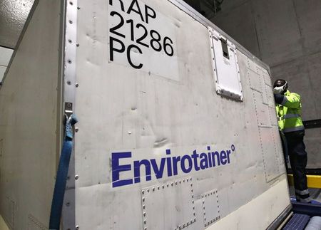 A employee working for the Pharma and Healthcare Logistics department at Kuehne+Nagel Group checks a container capable to be conditioned to be used for the transport of COVID-19 vaccines, in Machelen, Belgium November 17, 2020. Picture taken November 17, 2020. REUTERS/Yves Herman