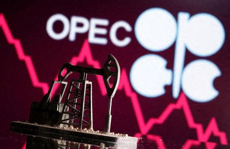 A 3D printed oil pump jack is seen in front of displayed stock graph and Opec logo in this illustration picture, April 14, 2020. REUTERS/Dado Ruvic/Illustration 