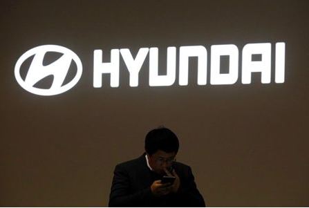 A man walks past the logo of Hyundai Motor during the 2019 Seoul Motor Show in Goyang, South Korea, March 28, 2019. REUTERS/Kim Hong-Ji
