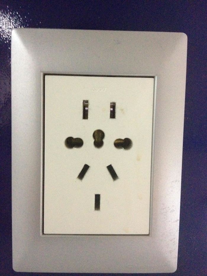 In The Airport, An Outlet That Fits Just About All The Plug Configurations In The World