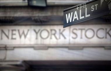 FILE PHOTO: A Wall Street sign is pictured outside the New York Stock Exchange in New York, October 28, 2013. REUTERS/Carlo Allegri/File Photo 