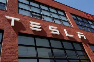 FILE PHOTO: The TESLA logo is seen outside a dealership in the Brooklyn borough of New York City, U.S., April 26, 2021. REUTERS/Shannon Stapleton