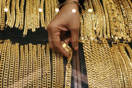 A vendor arranges gold chains displayed at VJ Gold and Diamond jewellery shop in Kuala Lumpur, Malaysia August 10, 2020. REUTERS/Lim Huey Teng 