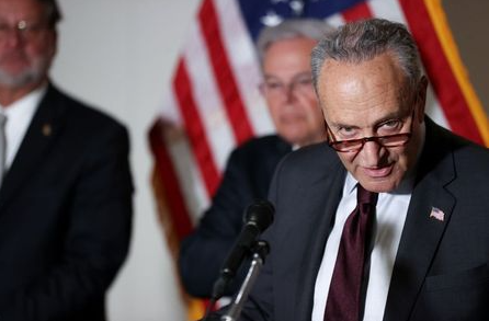 U.S. Senate Majority Leader Chuck Schumer (D-NY), with Senator Gary Peters (D-MI) and Senator Bob Menendez (D-NJ), speaks to reporters during the weekly news conference following the Democratic caucus policy luncheon on Capitol Hill in Washington, U.S. May 18, 2021. REUTERS/Jonathan Ernst