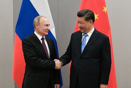 FILE PHOTO: Russian President Vladimir Putin shakes hands with Chinese President Xi Jinping during their meeting on the sidelines of a BRICS summit, in Brasilia, Brazil, November 13, 2019. Sputnik/Ramil Sitdikov/Kremlin via REUTERS