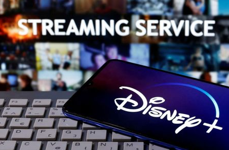 FILE PHOTO: A smartphone with the "Disney" logo is seen on a keyboard in front of the words "Streaming service" in this picture illustration taken March 24, 2020. REUTERS/Dado Ruvic/File Photo