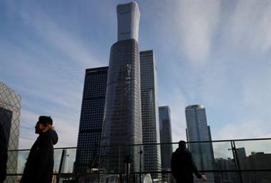 Men stand on a balcony overlooking the central business district in Beijing, China December 15, 2020. REUTERS/Thomas Peter 