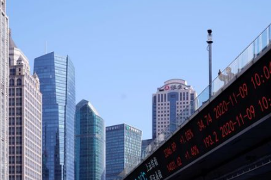 An electronic board showing Shanghai and Shenzhen stock indexes is seen on an overpass at the Lujiazui financial district in Shanghai, China November 9, 2020. REUTERS/Aly Song