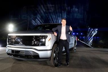Ford CEO Jim Farley poses with the all-electric Ford F-150 Lightning pickup truck during the unveiling at the company's world headquarters in Dearborn, Michigan, U.S., May 19, 2021. REUTERS/Rebecca Cook 