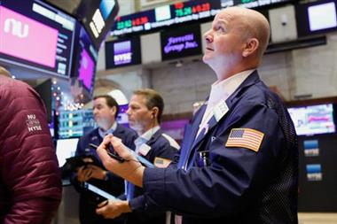 Traders work on the floor of the New York Stock Exchange (NYSE) in New York City, U.S., December 9, 2021. REUTERS/Brendan McDermid