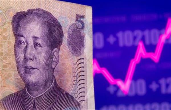 A Chinese Yuan banknote is seen in front of displayed stock graph in this illustration taken May 7, 2021. REUTERS/Dado Ruvic/Illustration 