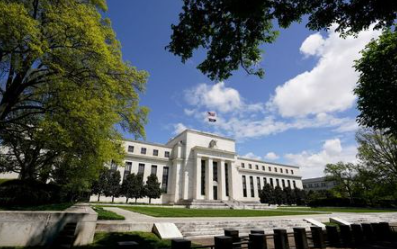 FILE PHOTO: The Federal Reserve building is set against a blue sky in Washington, U.S., May 1, 2020. REUTERS/Kevin Lamarque/File Photo