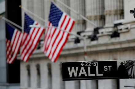 FILE PHOTO: American flags hang from the facade of the New York Stock Exchange (NYSE) building after the start of Thursday's trading session in Manhattan in New York City, New York, U.S., January 28, 2021. REUTERS/Mike Segar/File Photo