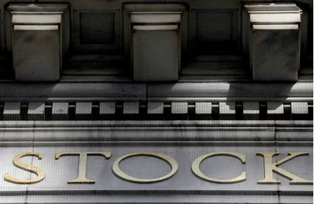 FILE PHOTO: Morning sunlight falls on the facade of the New York Stock Exchange (NYSE) building after the start of Thursday's trading session in Manhattan in New York City, New York, U.S., January 28, 2021. REUTERS/Mike Segar/File Photo