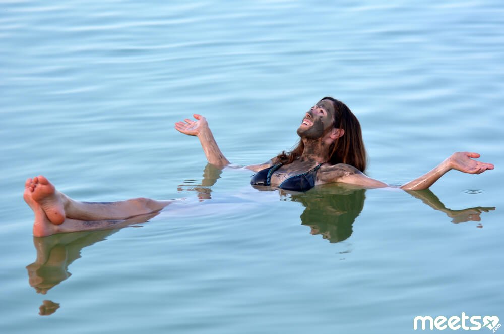 girl is bathing in the Dead Sea
