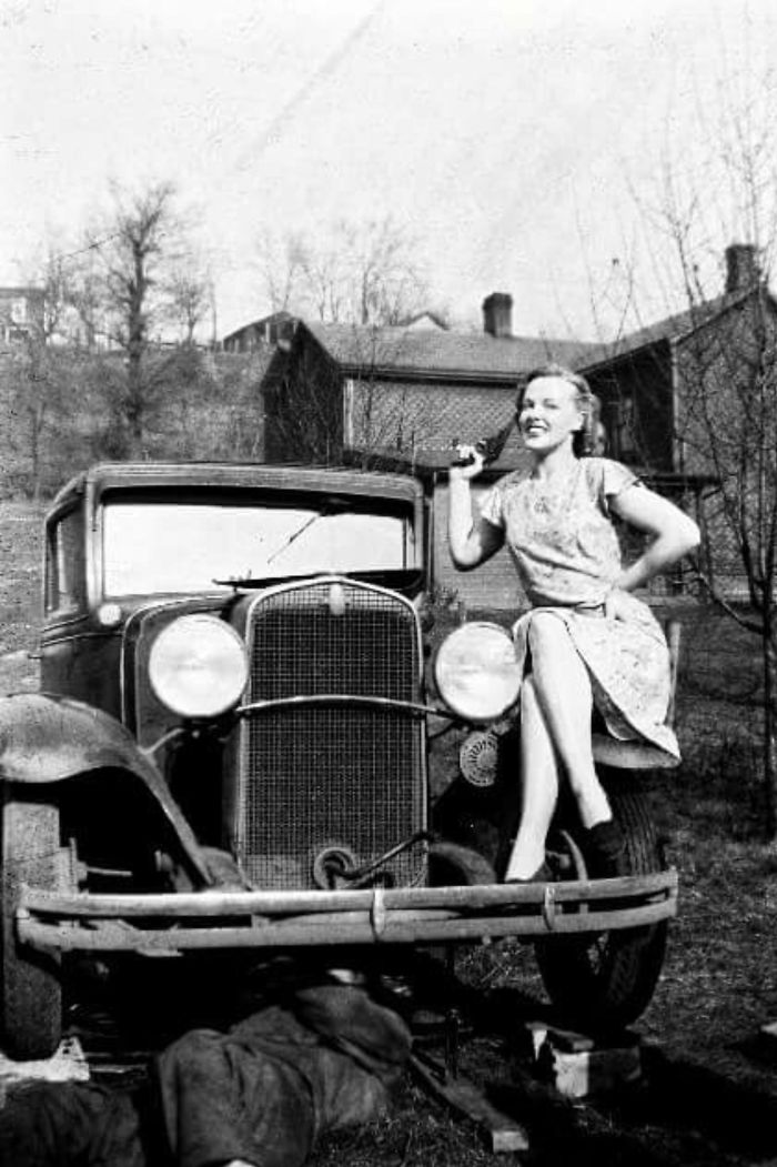 My Great Aunt Posing, While My Grandpa Fixes His Car, 1940s