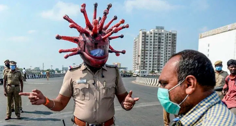 В Индии полицейский в шлеме коронавируса призывает людей оставаться дома