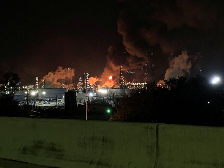 View from the road of a fire at petrochemical company ExxonMobil's refinery near Houston in Baytown, Texas, U.S., December 23, 2021 in this image obtained from social media. Molly Fitzpatrick via REUTERS THIS IMAGE HAS BEEN SUPPLIED BY A THIRD PARTY. MANDATORY CREDIT. NO RESALES. NO ARCHIVES