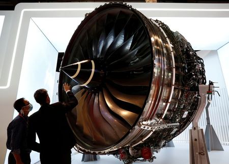 FILE PHOTO: People look at Rolls Royce's Trent Engine displayed at the Singapore Airshow in Singapore February 11, 2020. REUTERS/Edgar Su/File Photo