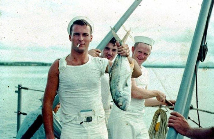 My Very Cool Grandpa In The 1950s Holding A Fish, Smoking A Cigarette, With A Book Tucked Into His Pants And Cigarette Pack In His Sleeve