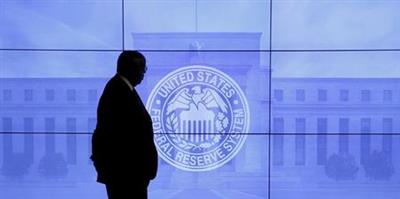 FILE PHOTO: A security guard walks in front of an image of the Federal Reserve in Washington, DC, U.S., March 16, 2016. REUTERS/Kevin Lamarque/File Photo 