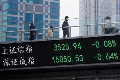 People wearing face masks, following the coronavirus disease (COVID-19) outbreak, walk on an overpass with an electronic board showing Shanghai and Shenzhen stock indexes, at the Lujiazui financial district in Shanghai, China January 6, 2021. REUTERS/Aly Song