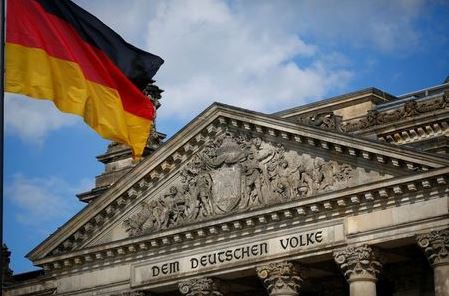 A German flag flutters in front of the Reichstag building in Berlin, Germany, September 6, 2020. Letters read 