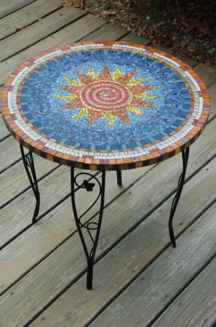  24 pretty outdoor table with a colorful sun mosaics and on forged legs