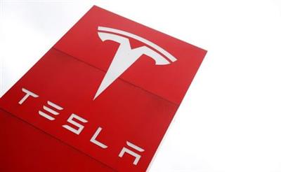 The logo of car manufacturer Tesla is seen at a dealership in London, Britain, May 14, 2021. REUTERS/Matthew Childs