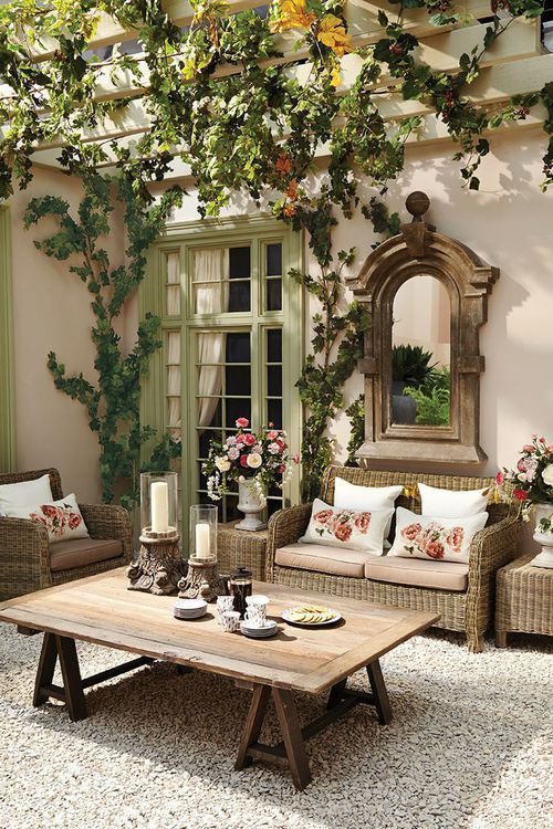  04 a patio that resembles a traditional living room with vintage touches and rustic furniture