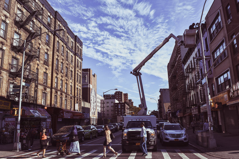 A contractor reattaches a wire that was damaged by construction.