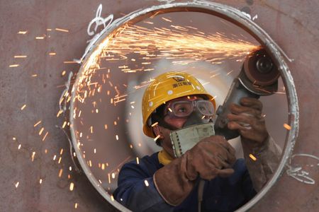 An employee works on a production line manufacturing steel structures at a factory in Huzhou, Zhejiang province, China May 17, 2020. Picture taken May 17, 2020. China Daily via REUTERS ATTENTION EDITORS - THIS IMAGE WAS PROVIDED BY A THIRD PARTY. CHINA OUT.