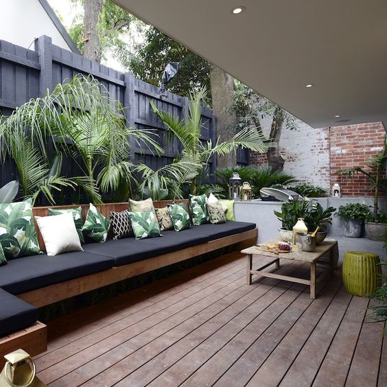  08 outdoor lounge with palm leaf print pillows to embrace the location