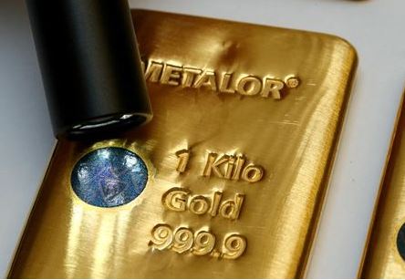 FILE PHOTO: The Sicpa Oasis validator system (bullion protect) is pictured on one kilogram bar of gold at Swiss refiner Metalor in Marin near Neuchatel, Switzerland July 5, 2019. REUTERS/Denis Balibouse/File Photo/File Photo