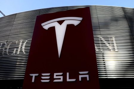 FILE PHOTO: A logo of the electric-vehicle maker Tesla is seen near a shopping complex in Beijing, China January 5, 2021. REUTERS/Tingshu Wang/File Photo