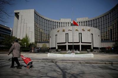 The Chinese national flag flies at half-mast at the headquarters of the People's Bank of China, the central bank (PBOC), as China holds a national mourning for those who died of the coronavirus disease (COVID-19), on the Qingming tomb-sweeping festival in Beijing, China April 4, 2020. REUTERS/Carlos Garcia Rawlins TPX IMAGES OF THE DAY