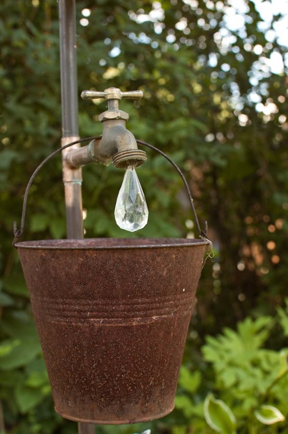 just a pipe and faucet from the hardware store and a crystal from the craft store, and an old bucket from the thrift shop.: 