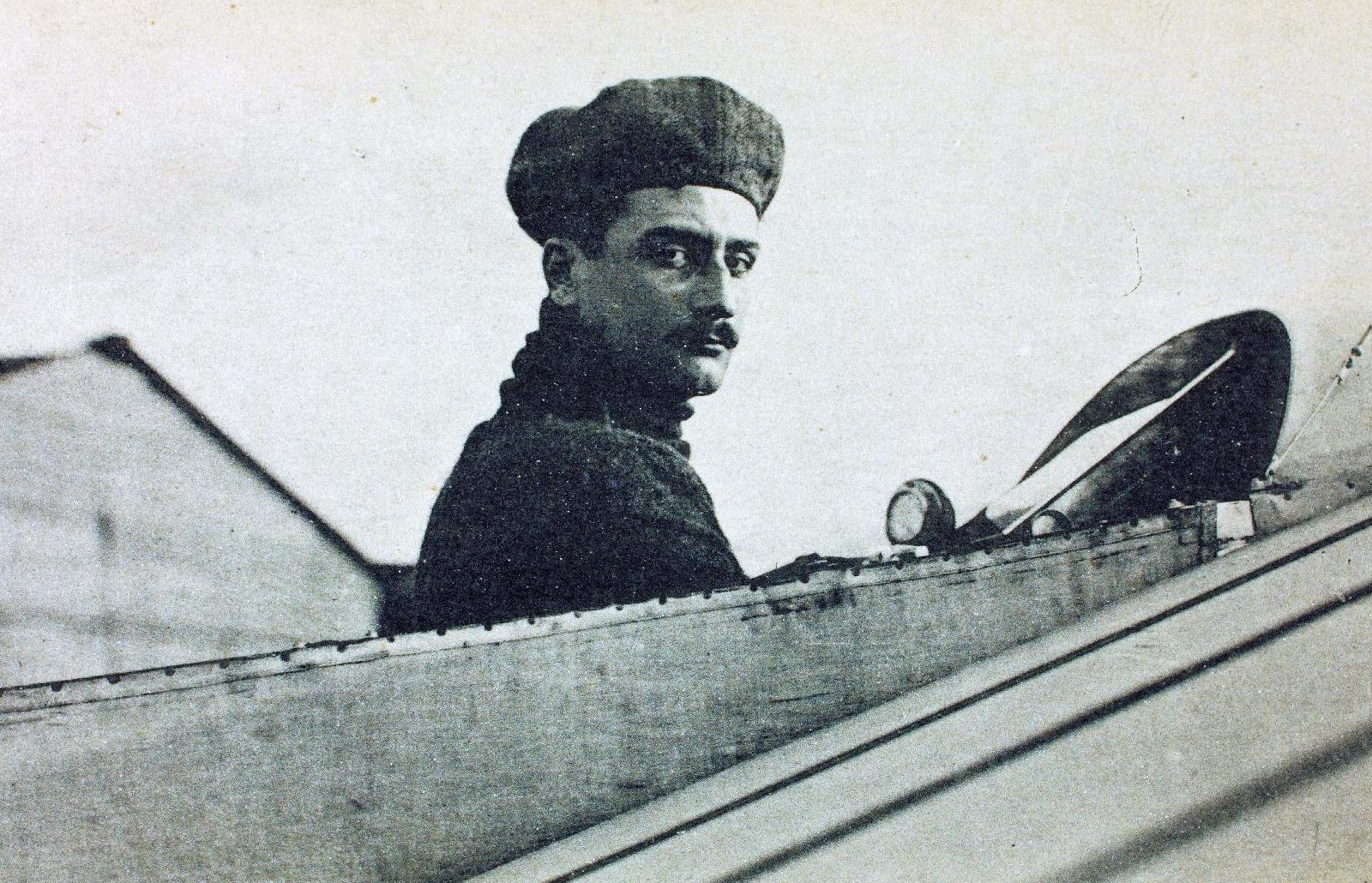 Bust and head of Roland Garros emerging from open cockpit of aircraft, looking at viewer
