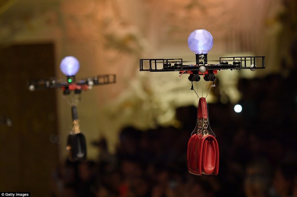 Two drones carrying handbags at the Dolce & Gabbana fashion show in Milan - part of the city