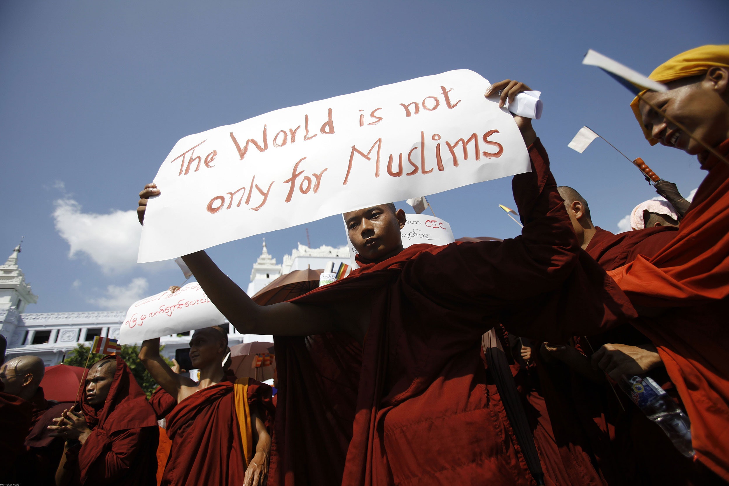 A Myanmar Buddhist monk holds a sign as he takes part in a demonstration against the Organisation of the Islamic Conference in Yangon on October 15, 2012. Thousands of monks took to the streets in Myanmar's two main cities on October 15 to protest against a world Islamic body's attempts to help Muslim Rohingya in unrest-hit Rakhine state, organisers said