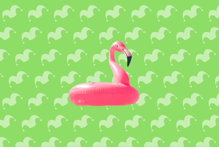 An inflatable flamingo over a green background