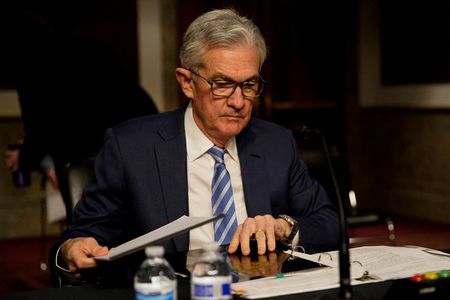 FILE PHOTO: Federal Reserve Chair Jerome Powell prepares to testify before a Senate Banking Committee hybrid hearing on oversight of the Treasury Department and the Federal Reserve on Capitol Hill in Washington, U.S., November 30, 2021. REUTERS/Elizabeth Frantz/File Photo