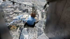A member of the media rides the Skyslide from the 70th to 69th floor of the U.S. Bank Tower which is attached to the OUE Skyspace LA observation deck in downtown Los Angeles, California, U.S., June 23, 2016. REUTERS/Bob Riha, Jr.