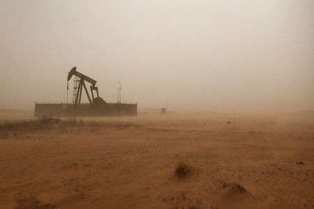 A pump jack lifts oil out of a well during a sandstorm in Midland, Texas, U.S., April 13, 2018. Picture taken April 13, 2018. REUTERS/Ann Saphir